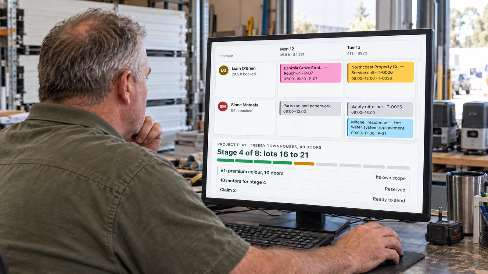 A garage-door business owner checks service bookings and a staged Treeby project on EasyDone in his Canning Vale workshop.